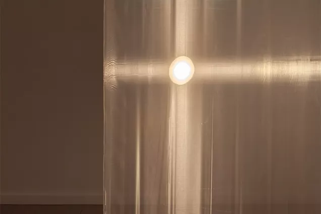 A light shining through a curtain. photo. 