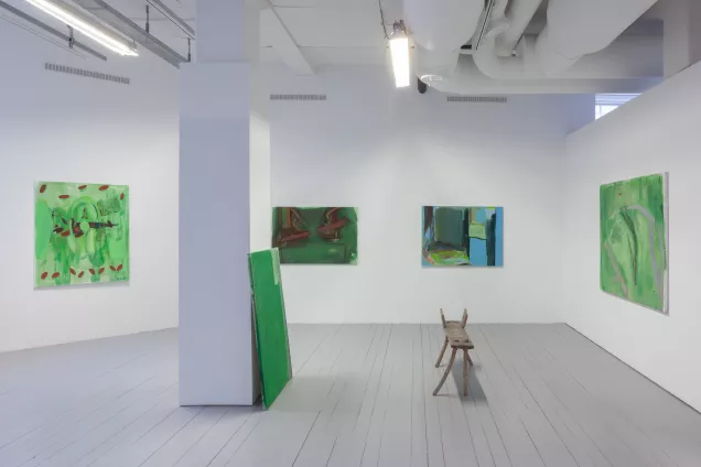 Exhibition with different green colored paintings. photo. 